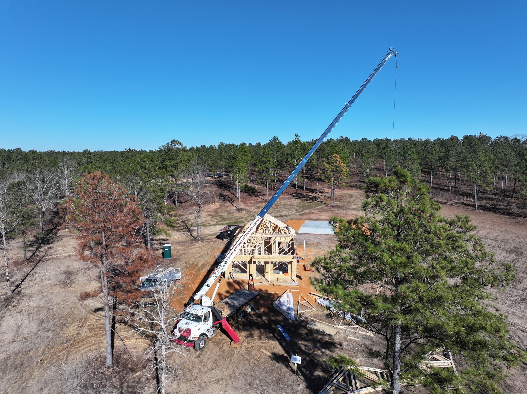 Crane lifting roof trusses on the Midland framing site